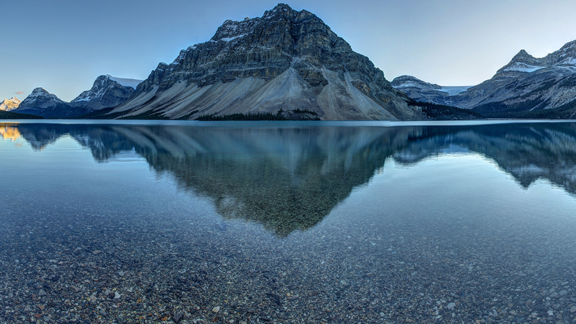 Header image of mountains reflected in a lake